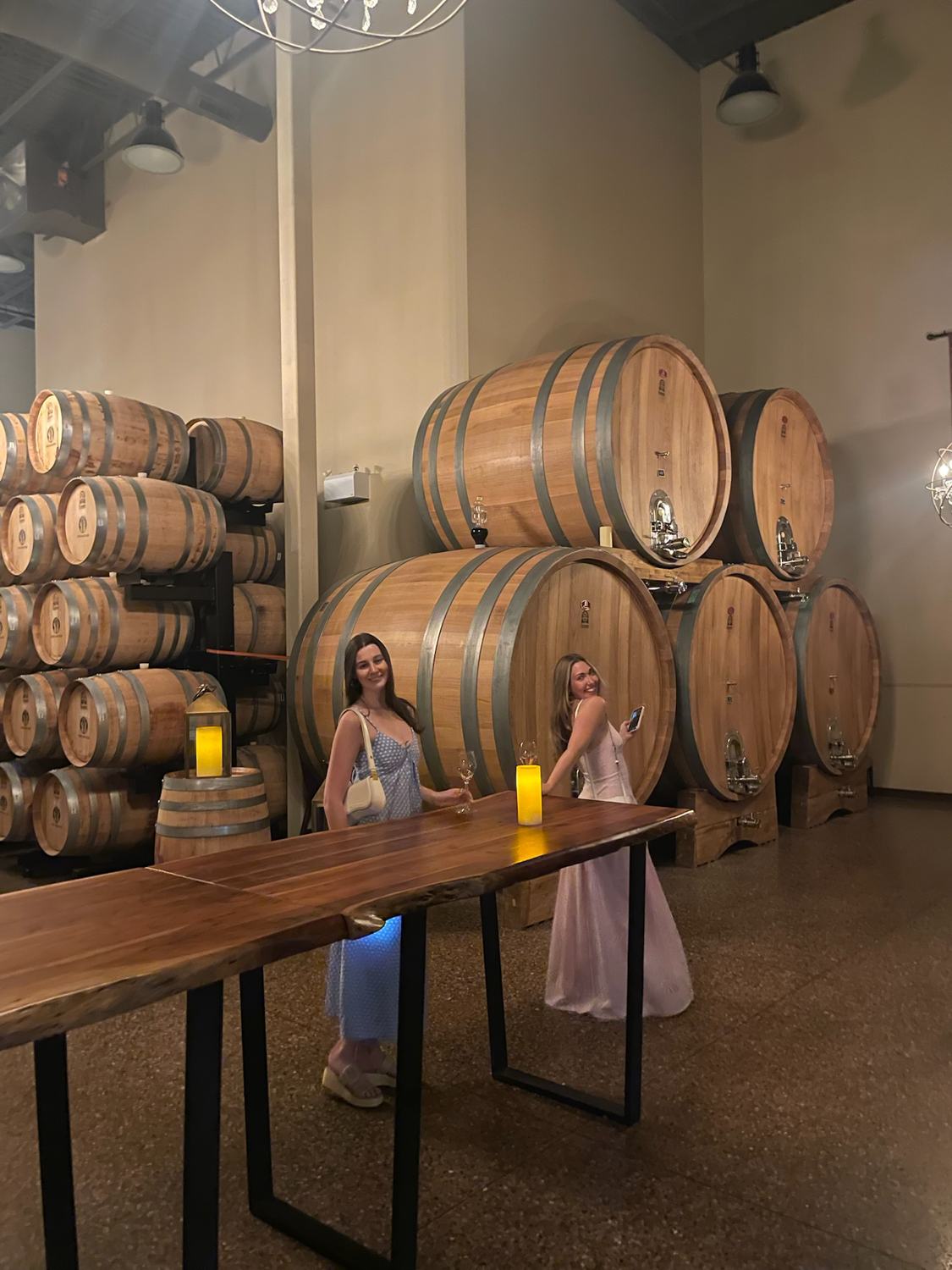 Two members beside the barrels in the cellar at Château des Charmes