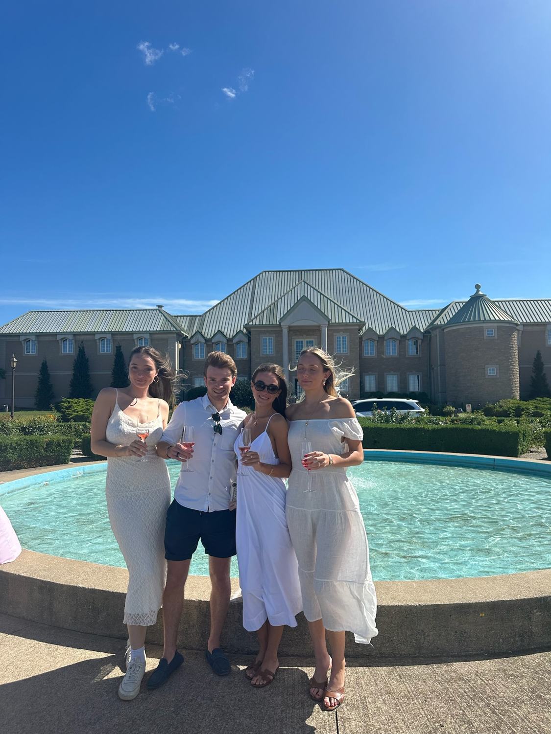 Members at the fountain in front of Château des Charmes