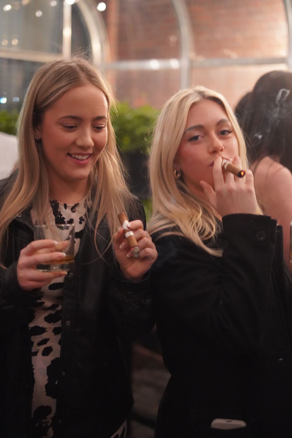 Two members with cigars at Hendry House