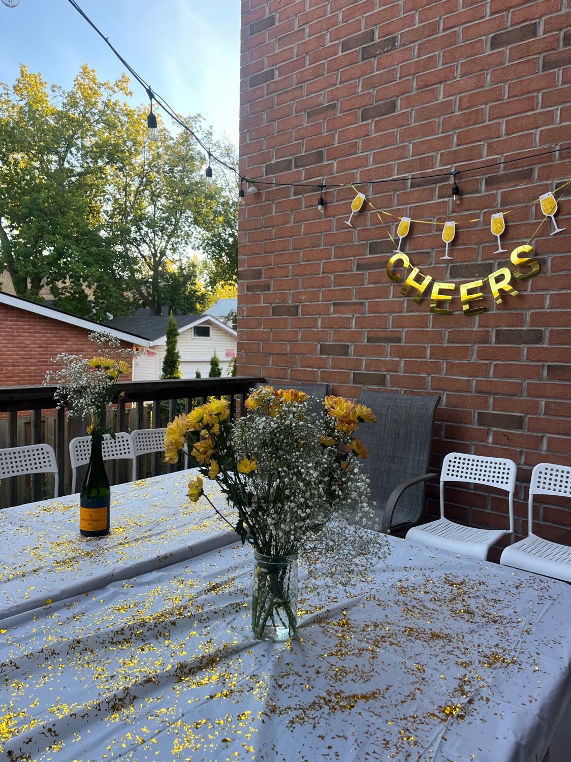 A table dressed with flowers and bottles in the afternoon sun