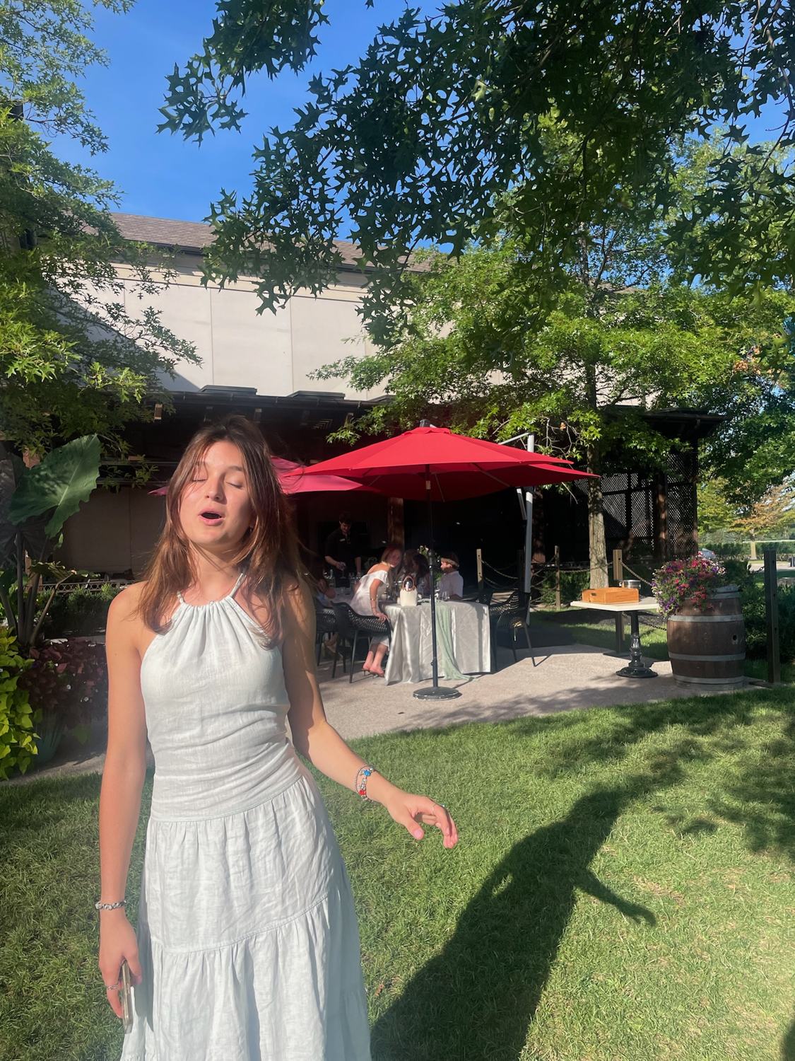 A member in a white dress on the lawn
