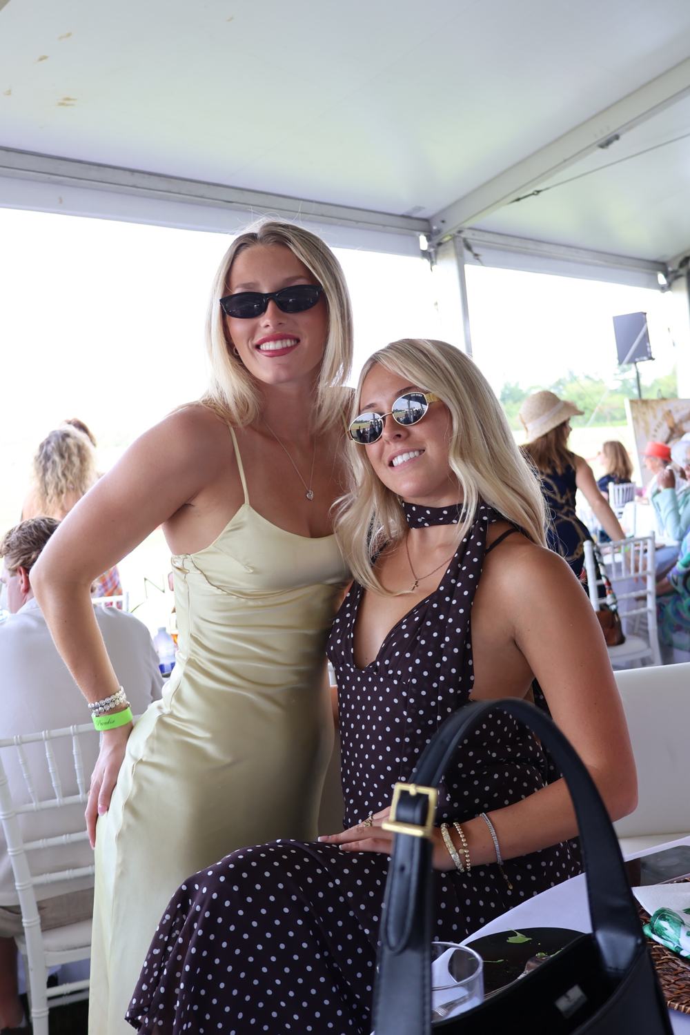 Two members under the marquee at the polo
